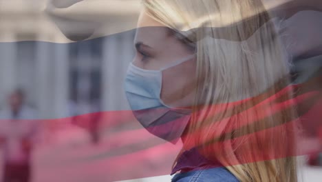 Animation-of-flag-of-russia-waving-over-woman-wearing-face-mask-during-covid-19-pandemic