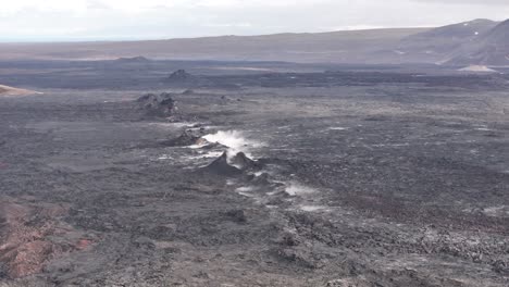 drone view of volcanic fissure in iceland with steaming cracks and rugged lava fields, natural landscape and geology