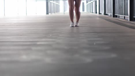 person performs jumping exercise on a modern bridge