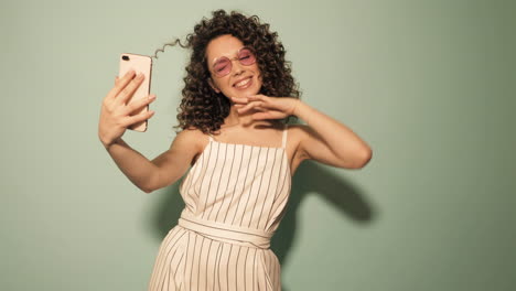 woman taking a selfie in a striped dress