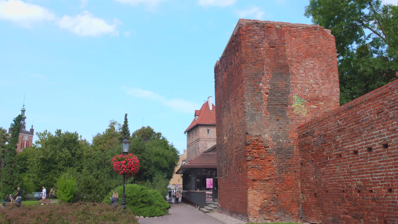 Profile view of exterior brick architecture Old town Wall in Gdansk, Poland during daytime. 4k.