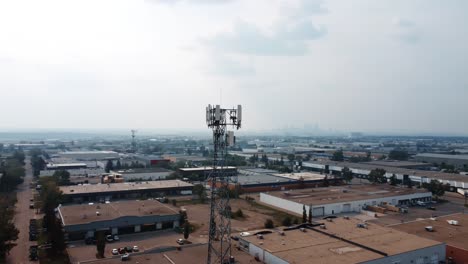 Aerial-orbiting-shot-of-the-radio-cell-tower-with-Calgary-downtown-in-the-background-in-summertime