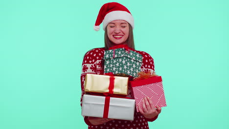 Woman-in-Christmas-red-sweater,-Santa-hat-smiling-holding-many-gift-boxes-New-Year-presents-shopping