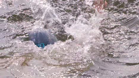 Indian-man-swimmer-swimming-in-river-open-water-with-swimming-cap-and-goggles-close-up