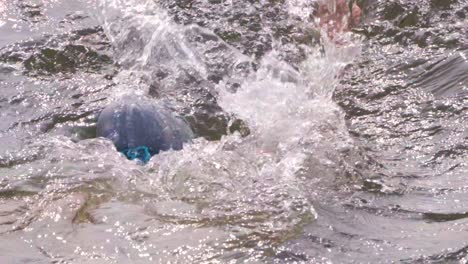 nadador indio nadando en aguas abiertas del río con gorra de natación y gafas de protección cercanas