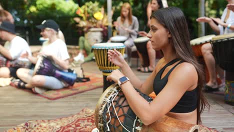 people drumming together outdoors