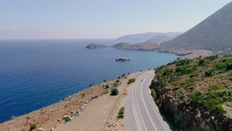 a shot from a drone of a road on the coast of the greek island of crete