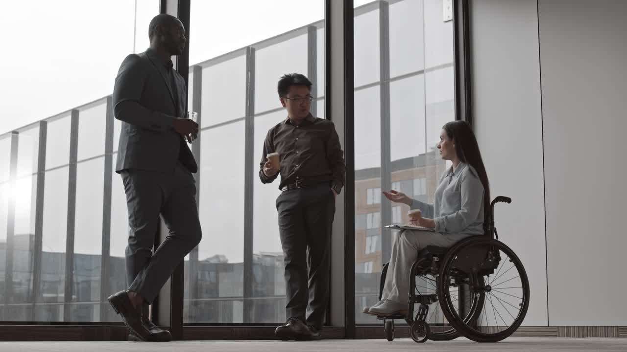 Businesswoman with Disability Having Chat with Two Male Colleagues