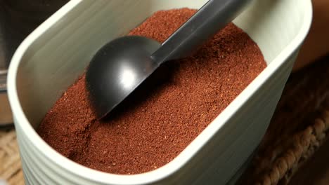 ground coffee in container with scoop