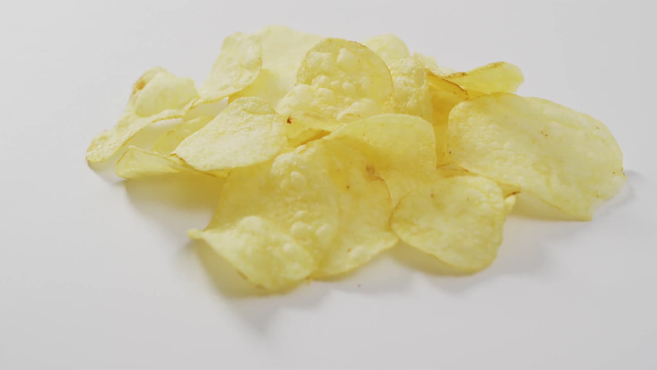 Close up of potato chips with copy space on white surface