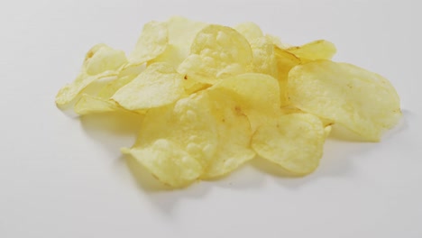 close up of potato chips with copy space on white surface