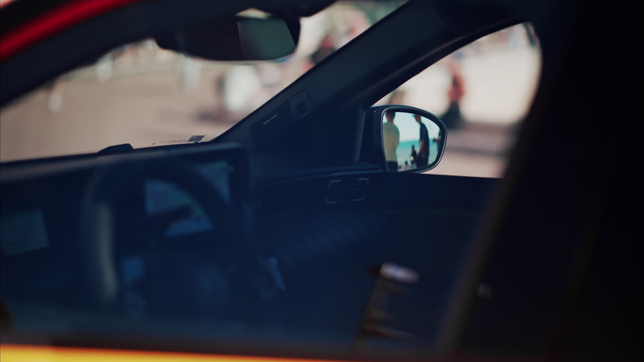 Close up view of the inside of a yellow car on the street