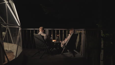 couple enjoying a romantic night on a deck