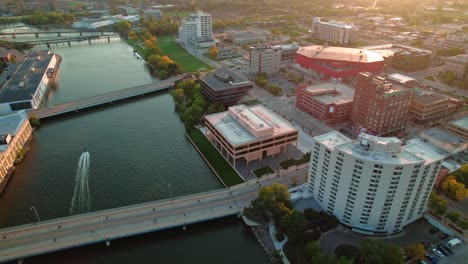 from-speed-boat-on-rock-river-to-beautiful-Rockford-downtown-in-Illinois,-USA-at-sunset