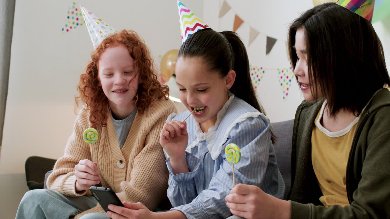 Girls licking lollipops