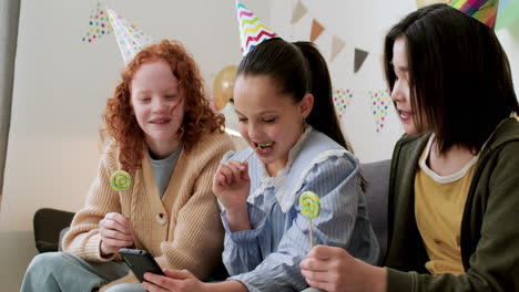 girls licking lollipops