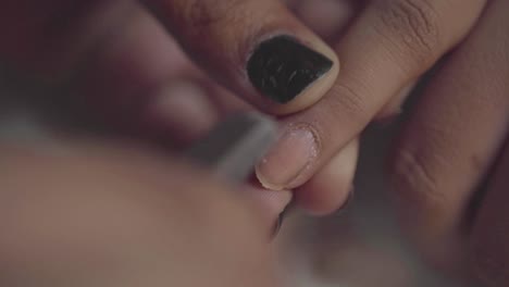 closeup of trimming nail cuticles during a manicure at a salon