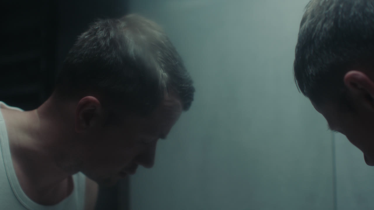 A sad man in the bathroom during his morning routine