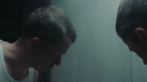 a sad man in the bathroom during his morning routine