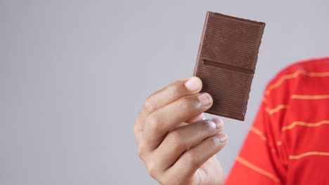 person holding a chocolate bar