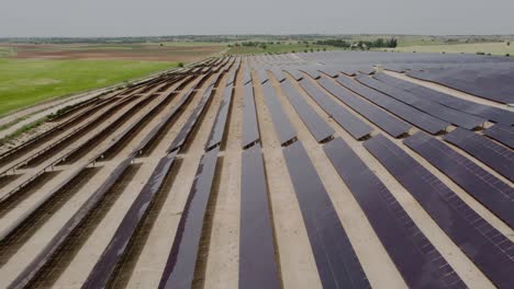 aerial drone view of solar panels of a solar energy generation farm also called solar park, for the supply of merchant power into the electricity grid