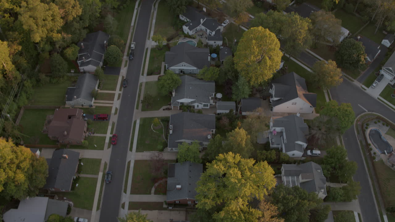Straight down over houses in St. Louis tilt up to reveal horizon