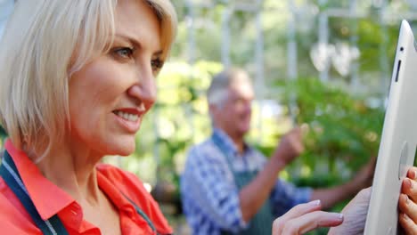 mature woman using digital tablet