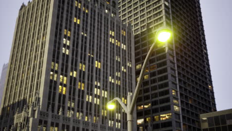 city buildings illuminated at dusk with streetlights glowing softly