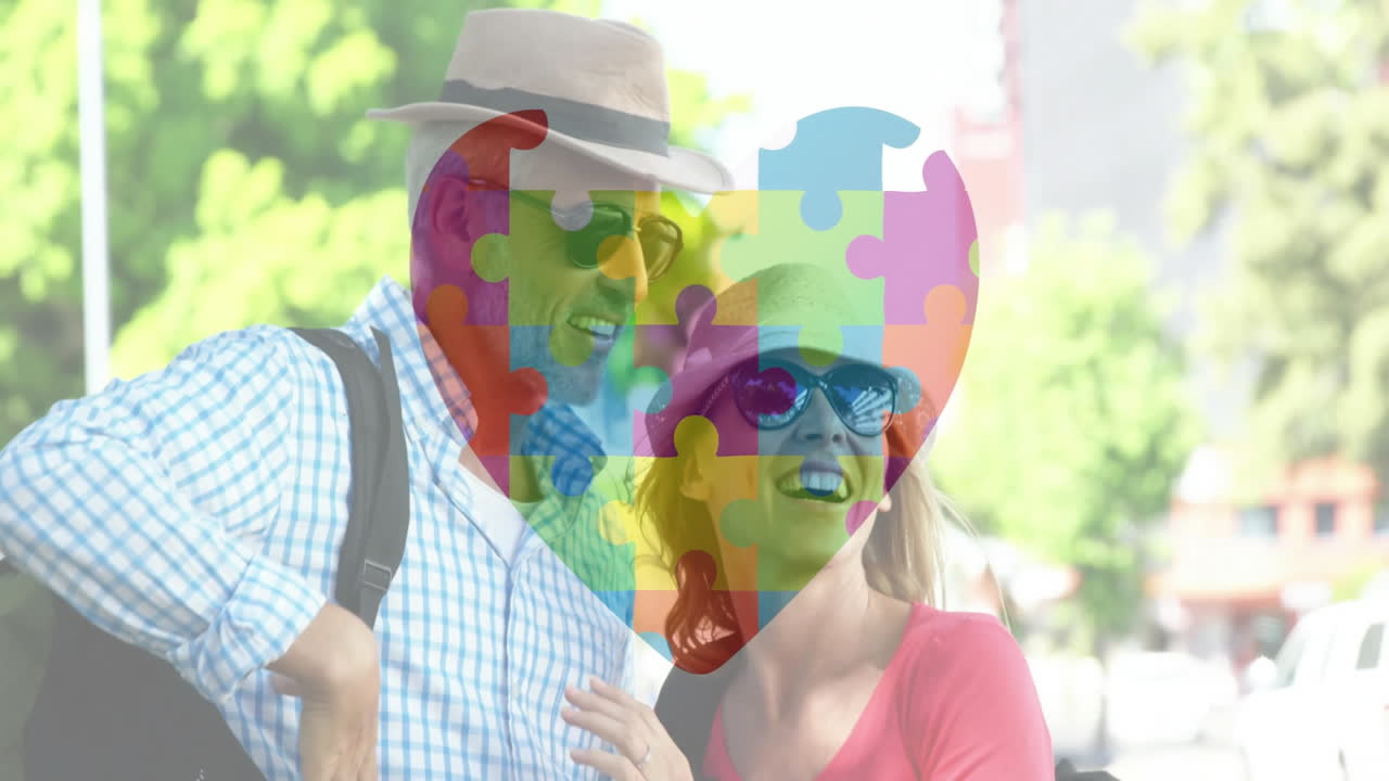 Holding colorful heart puzzle, smiling couple outdoors enjoying time together