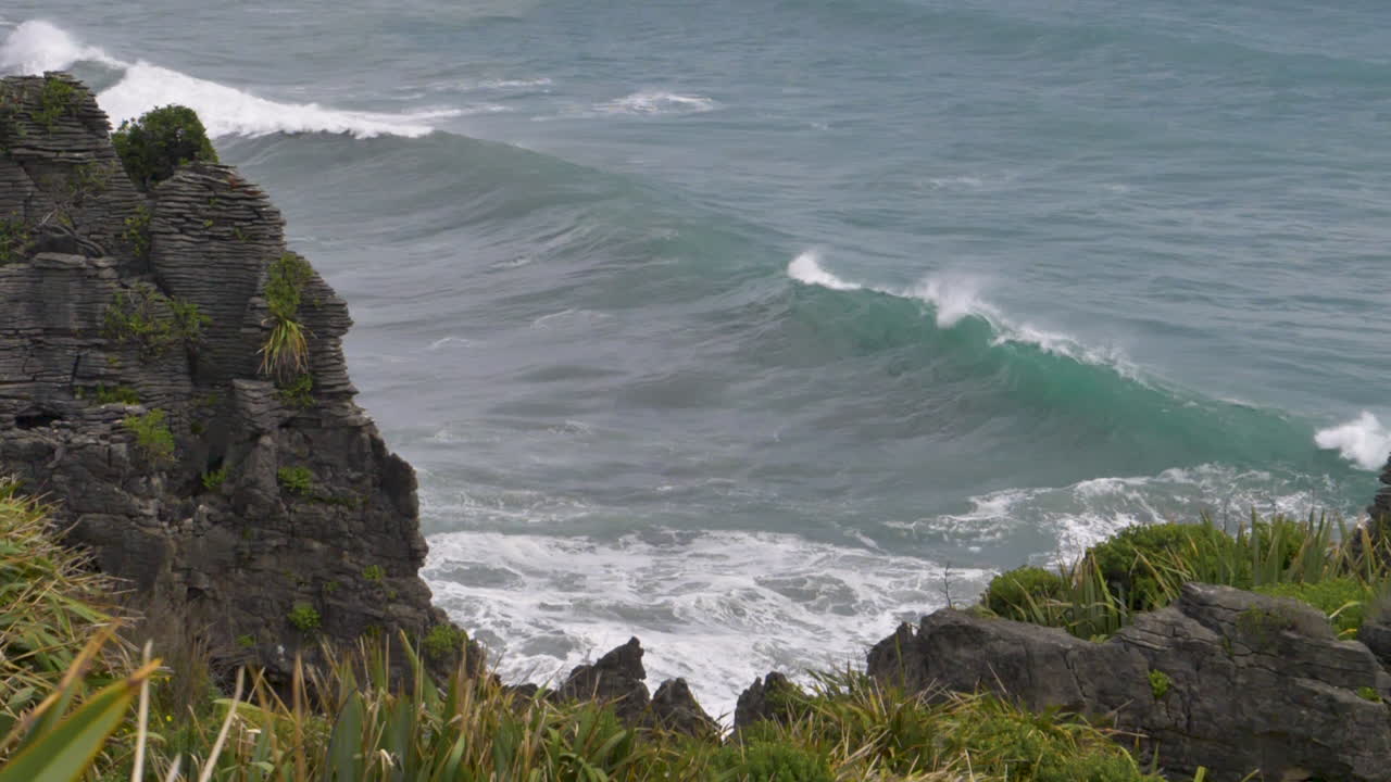 Wave crests in slow motion off of cliffs - Punakaiki, New Zealand