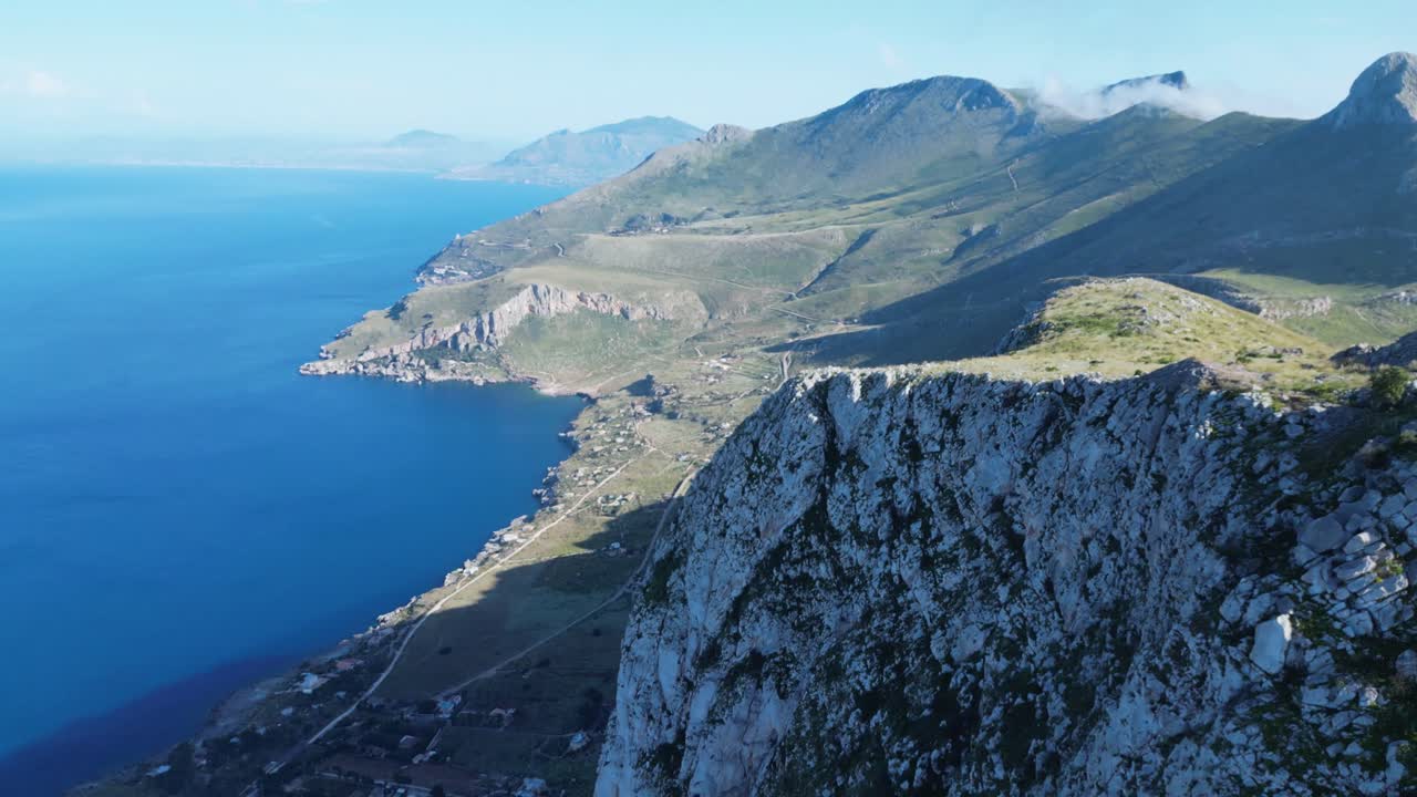 Aerial drone footage of Monte Monaco, San Vito Lo Capo, Sicily: 360° panoramic view of sea and mountains under golden Mediterranean light. Perfect for travel, nature, and adventure projects