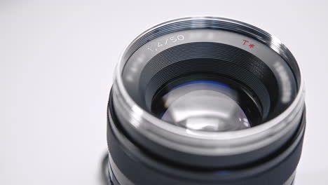 black lens with glass and metal on white studio background