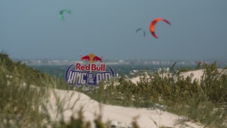 red bull king of the air sign and kites in background; bloubergstrand
