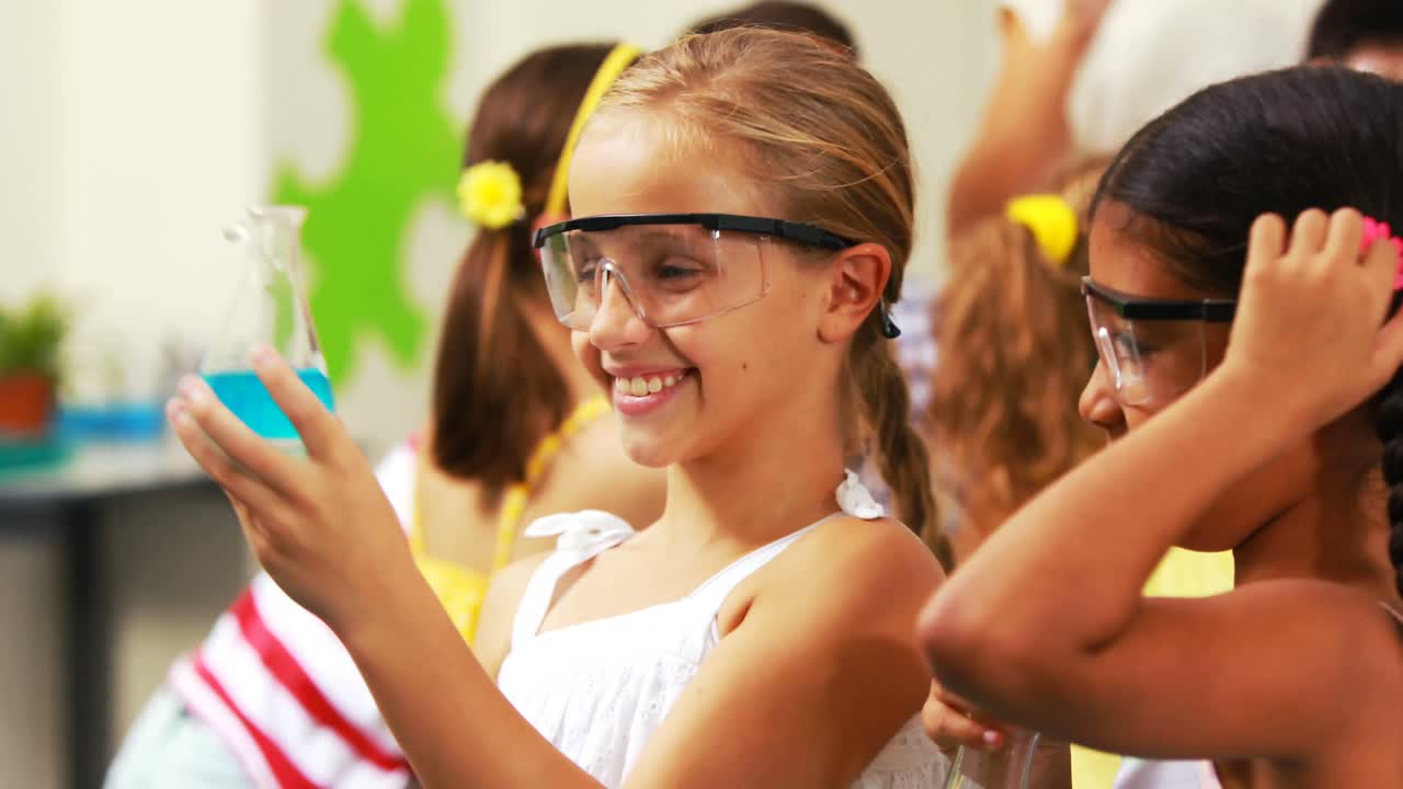 Portrait of kids holding laboratory flask in laboratory