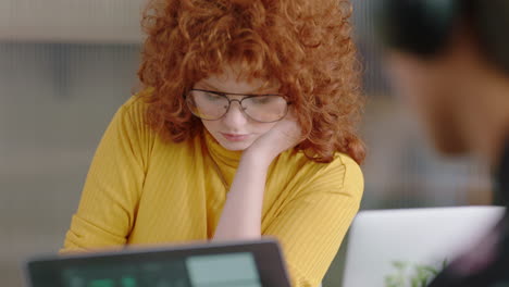 beautiful-young-redhead-business-woman-writing-notes-brainstorming-creative-ideas-working-in-modern-office-wearing-glasses