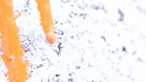orange paint drips on white surface