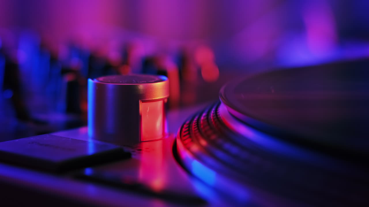 A working record player with a rotating vinyl record. Neon blue and red illumination around