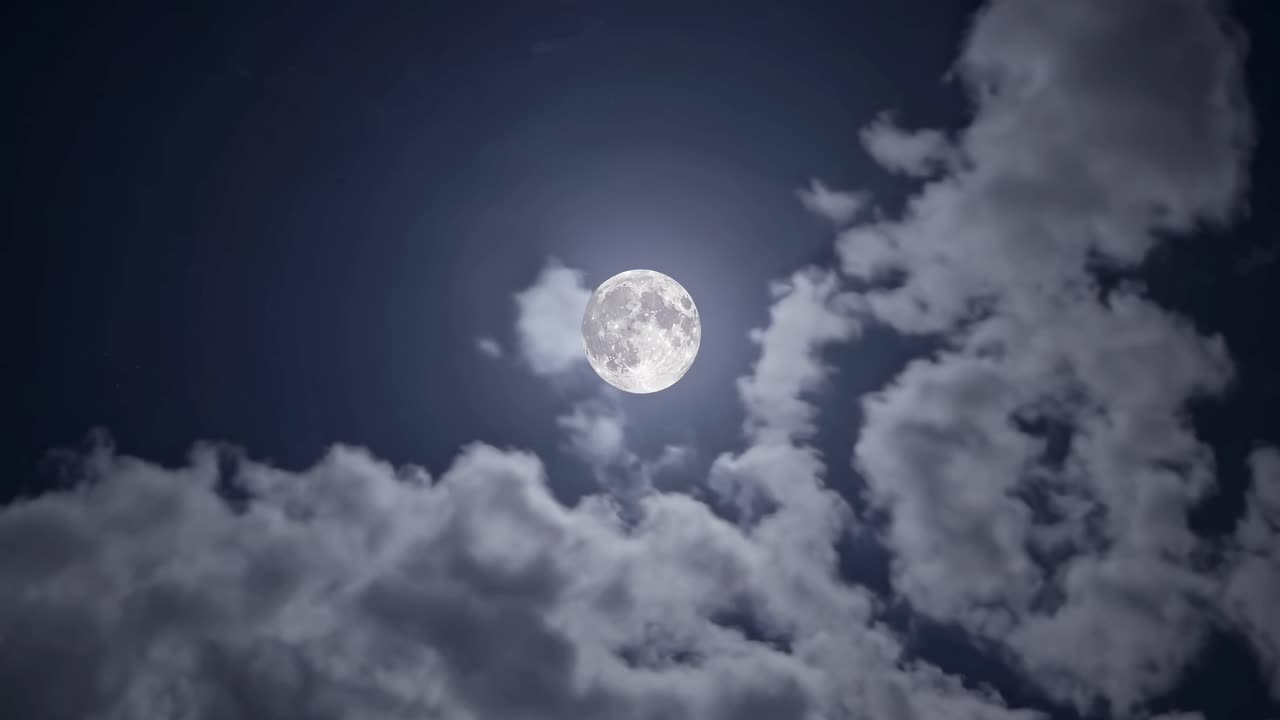 A serene night sky video with a full moon surrounded by drifting clouds