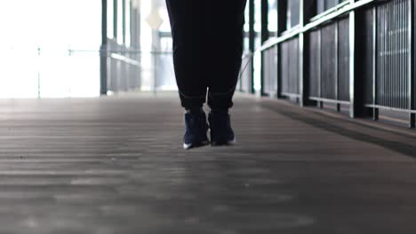 person performing jump rope workout indoors