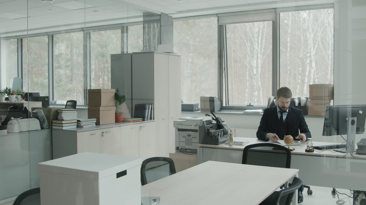 Male Lawyer Working with Papers in Office