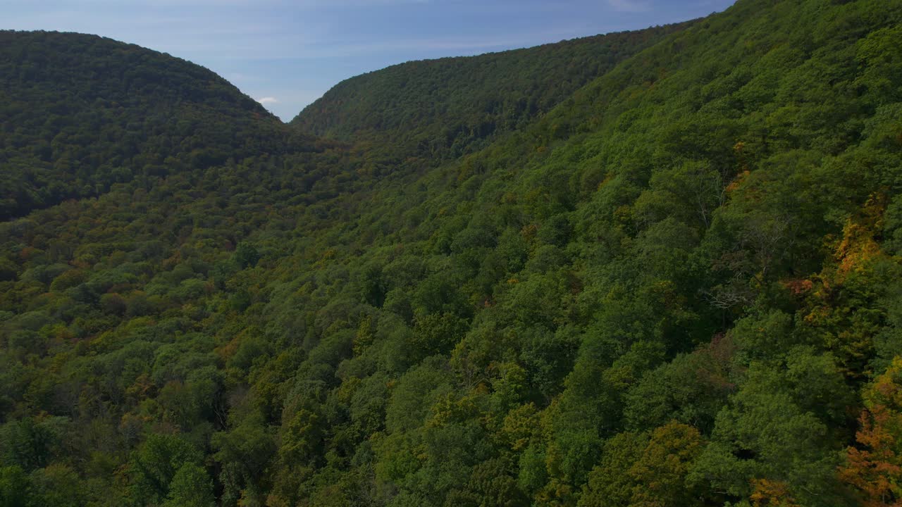 Breathtaking aerial footage of a warm, magical early autumn day over the vibrant Appalachian Mountains, capturing sweeping views of fall foliage, lush landscapes, and atmospheric scenery.
