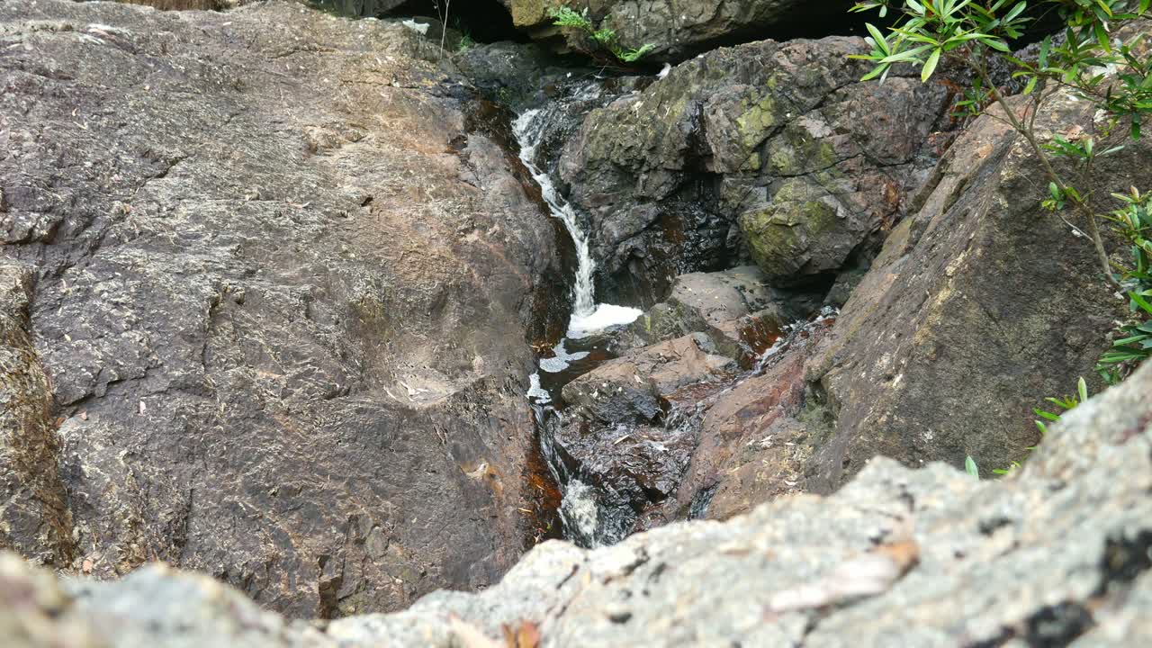 Water flowing over the rocks at Youngs Creek Falls, north of Orbost, Gippsland, Victoria, Australia, December 2020