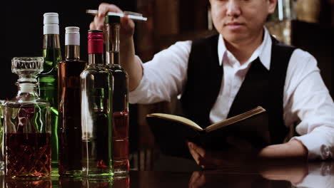 bartender checking alcohol bottles