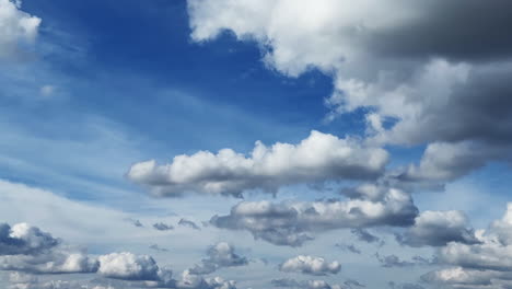 little fluffy cumulus clouds changing shape in the atmosphere. low angle view at the clouds floating in the sky. timelapse.