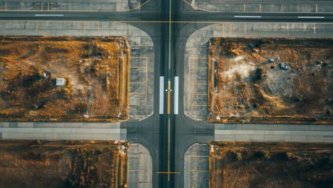 airport intersection revealing geometric taxiways and runways spreading across surrounding landscape, capturing expansive transportation infrastructure from aerial perspective