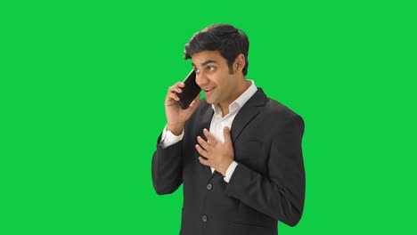 Happy-Indian-manager-talking-to-someone-on-call-Green-screen