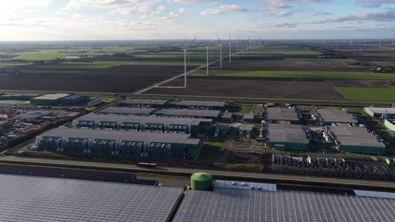 Aerial drone footage of large-scale computing and telecommunications infrastructure, showing an advanced datacenter complex with server systems, cloud connectivity, and digital technology in Hollands