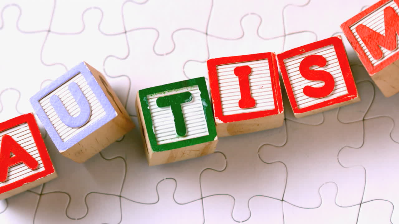 Autism blocks falling onto jigsaw surface