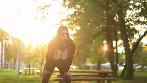 woman exercising in the park at sunrise