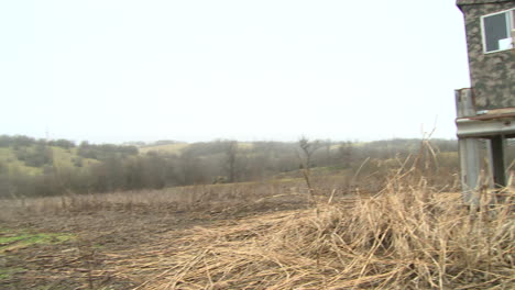 a hunting blind looking over a corn field in iowa